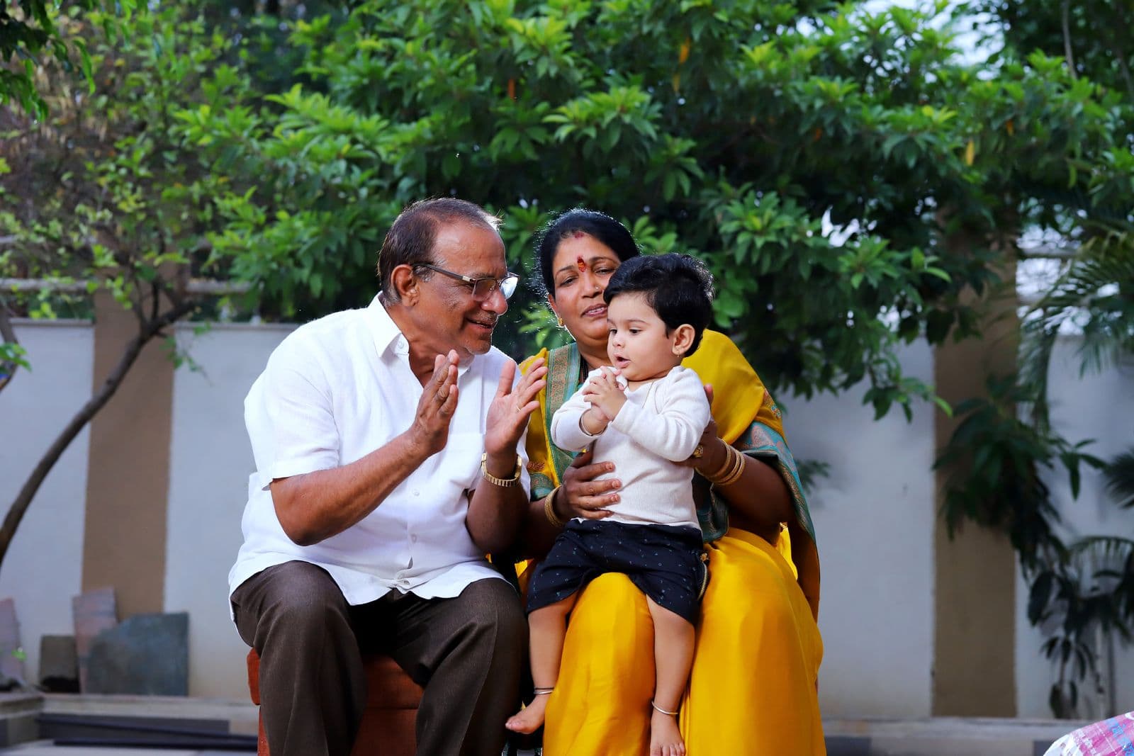 Parents sitting with their child at home